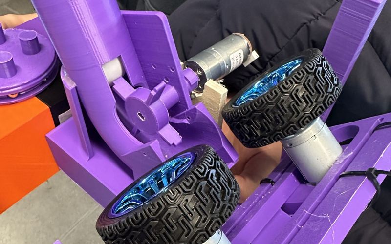 The cup pong robot: purple 3D-printed frame with a launch tube and twin flywheels